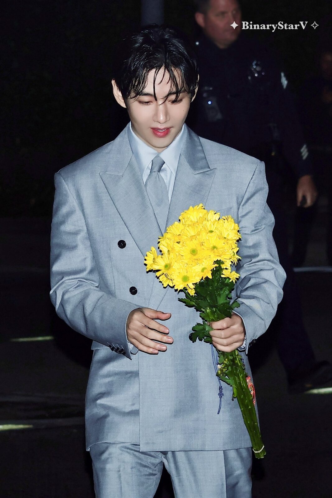 V holding flower bouquet