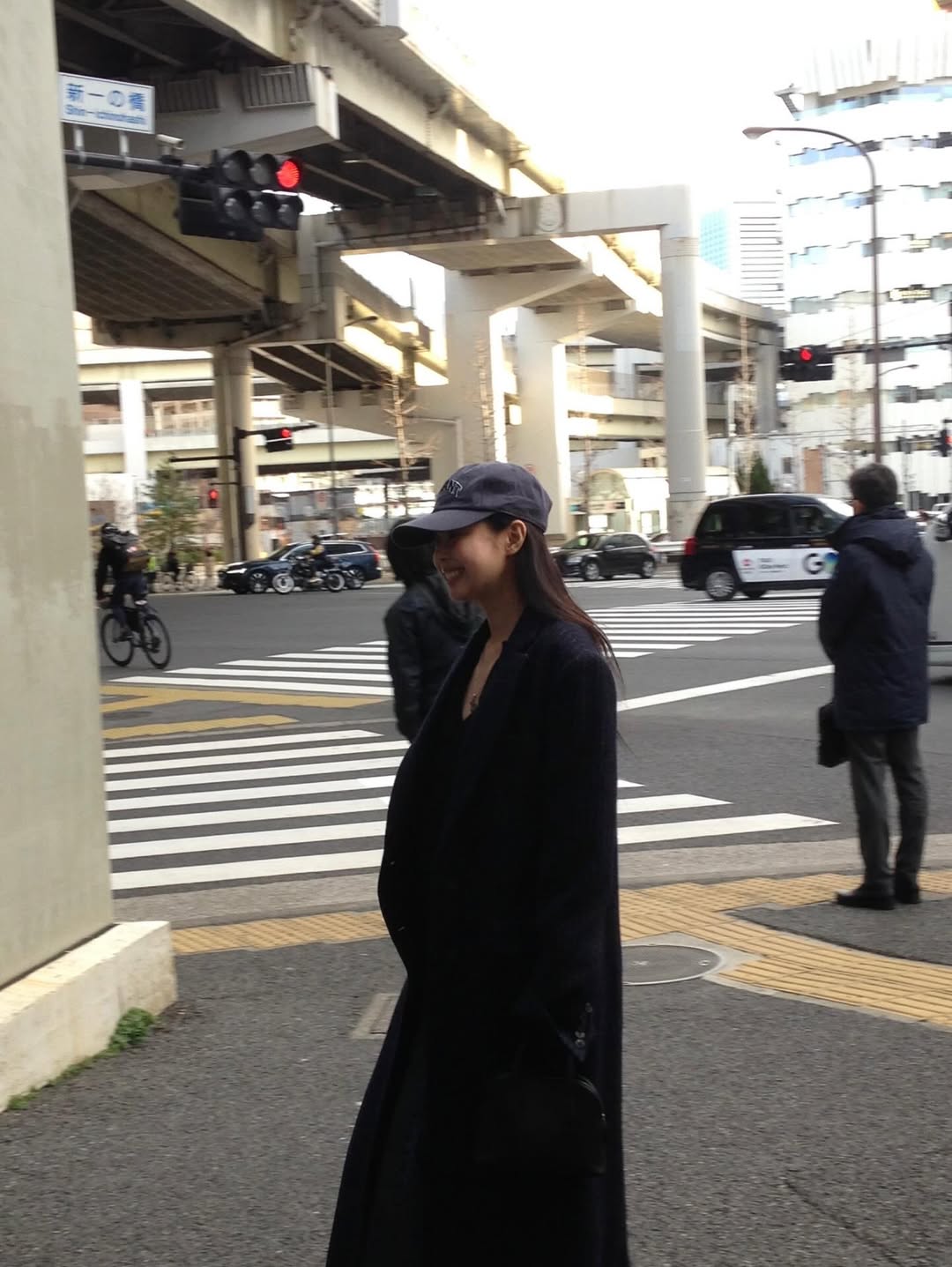 Jennie in a baseball cap hiding part of her face